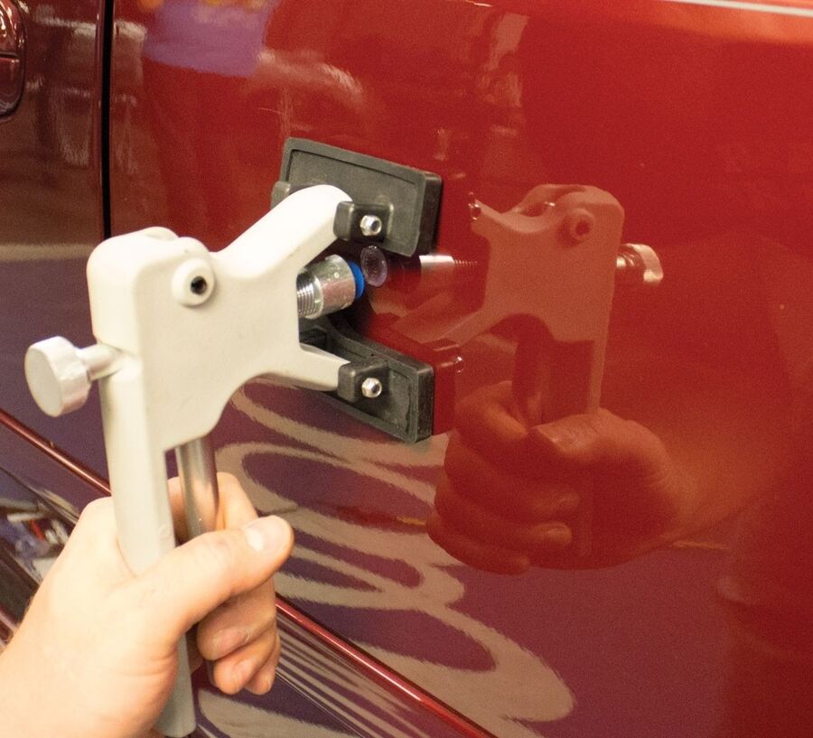 Dent lifter tool removing a ding